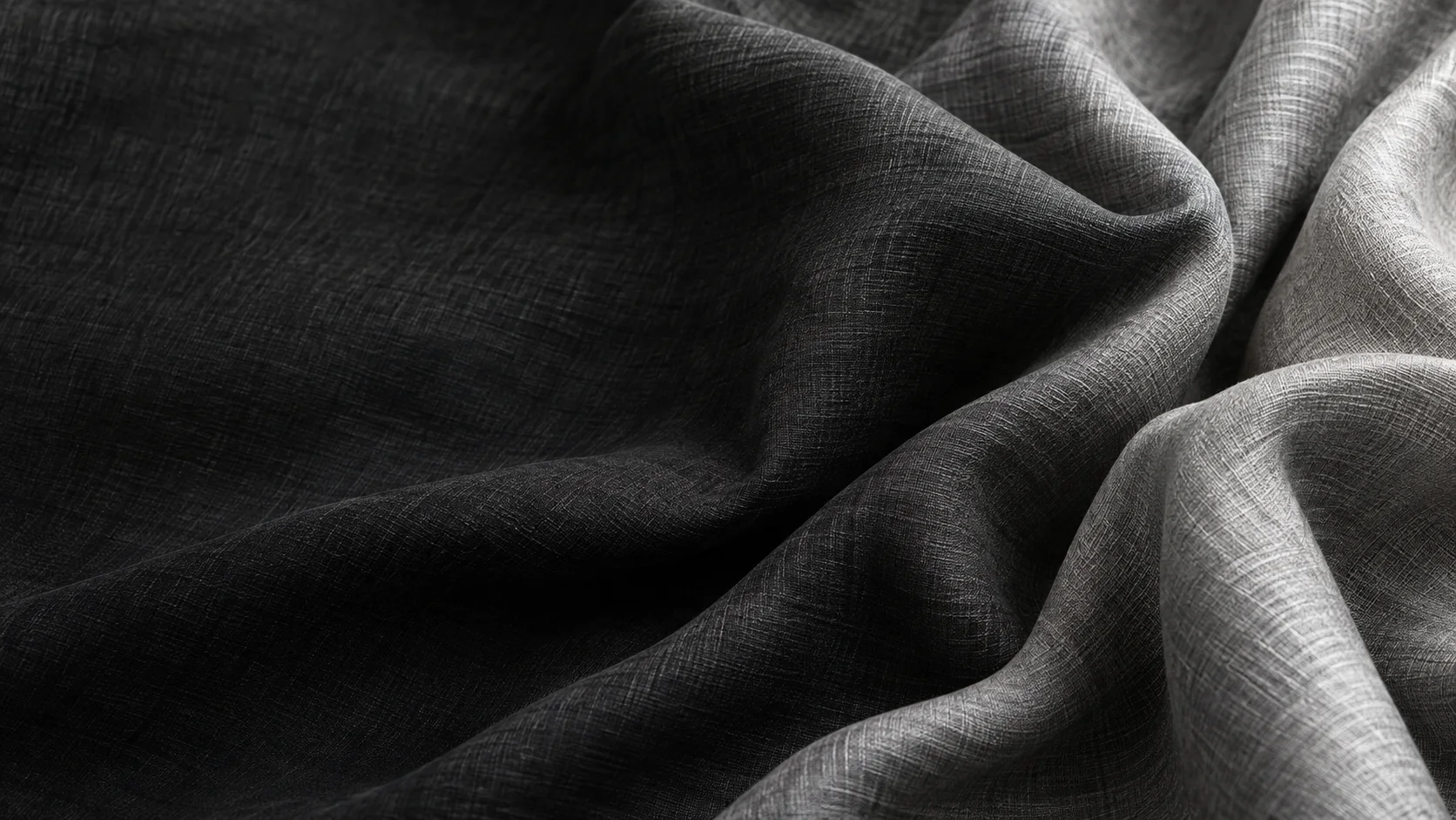 Soft charcoal cotton–rayon fabric flowing into silver folds
